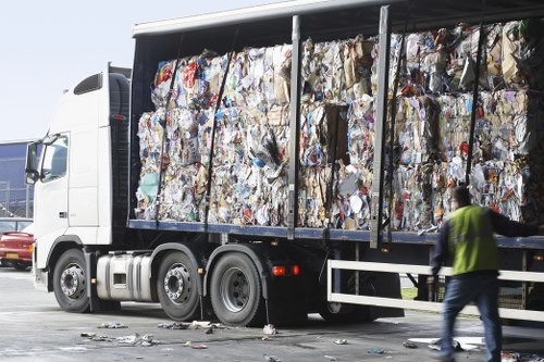 A waste removal truck operating in an industrial area