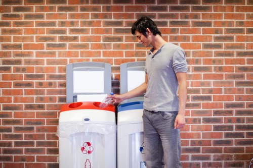 Workers using lifting aids during rubbish removal